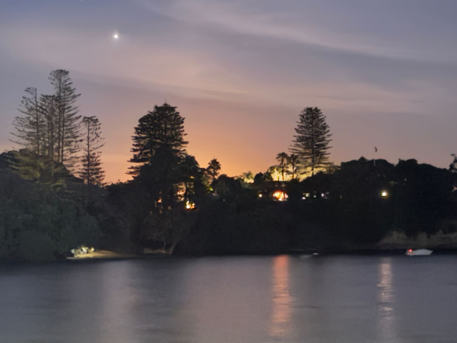 Blue hour over the headland with house lights and Venus above