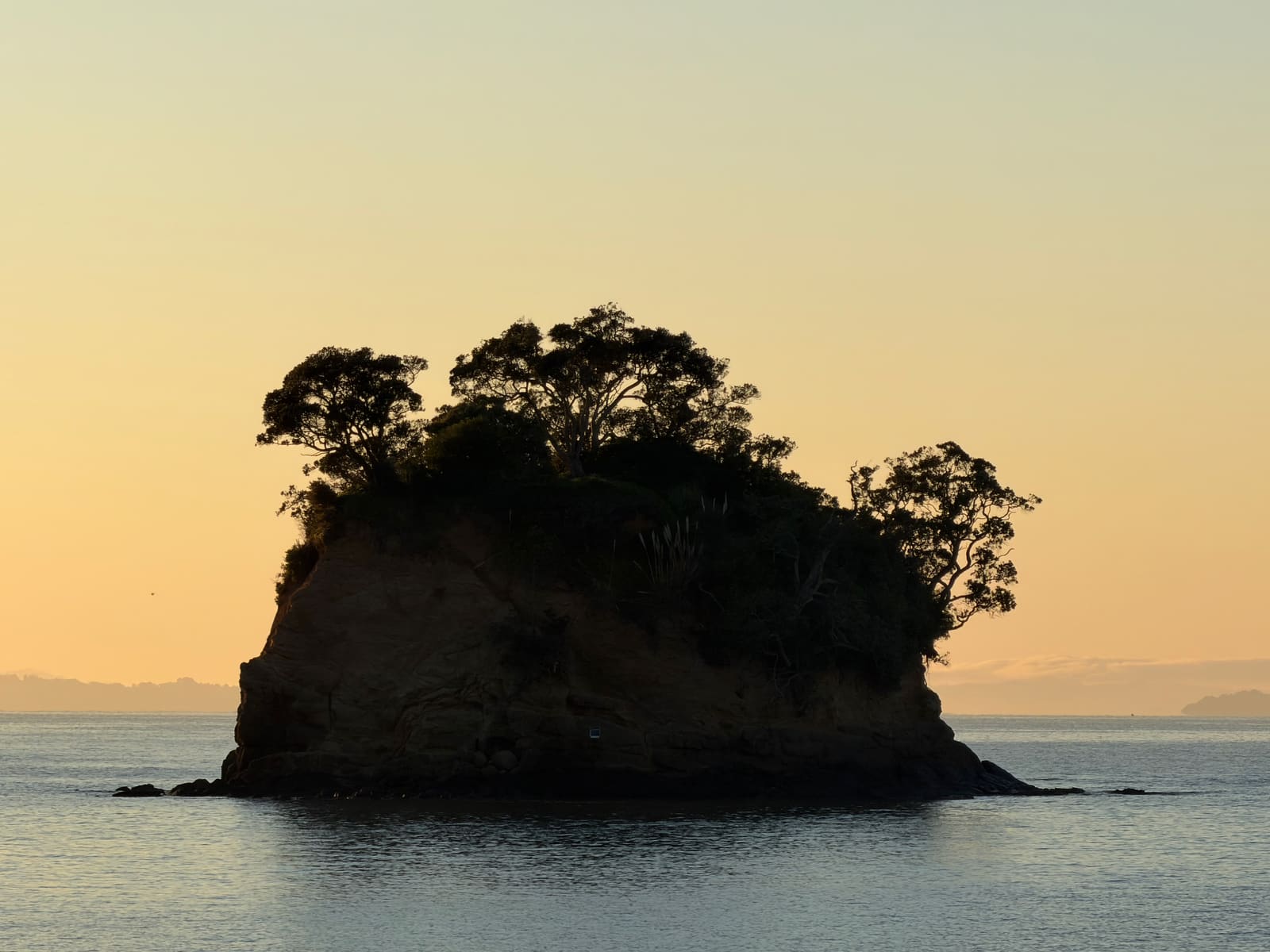 The Tor at dawn in golden sea mist