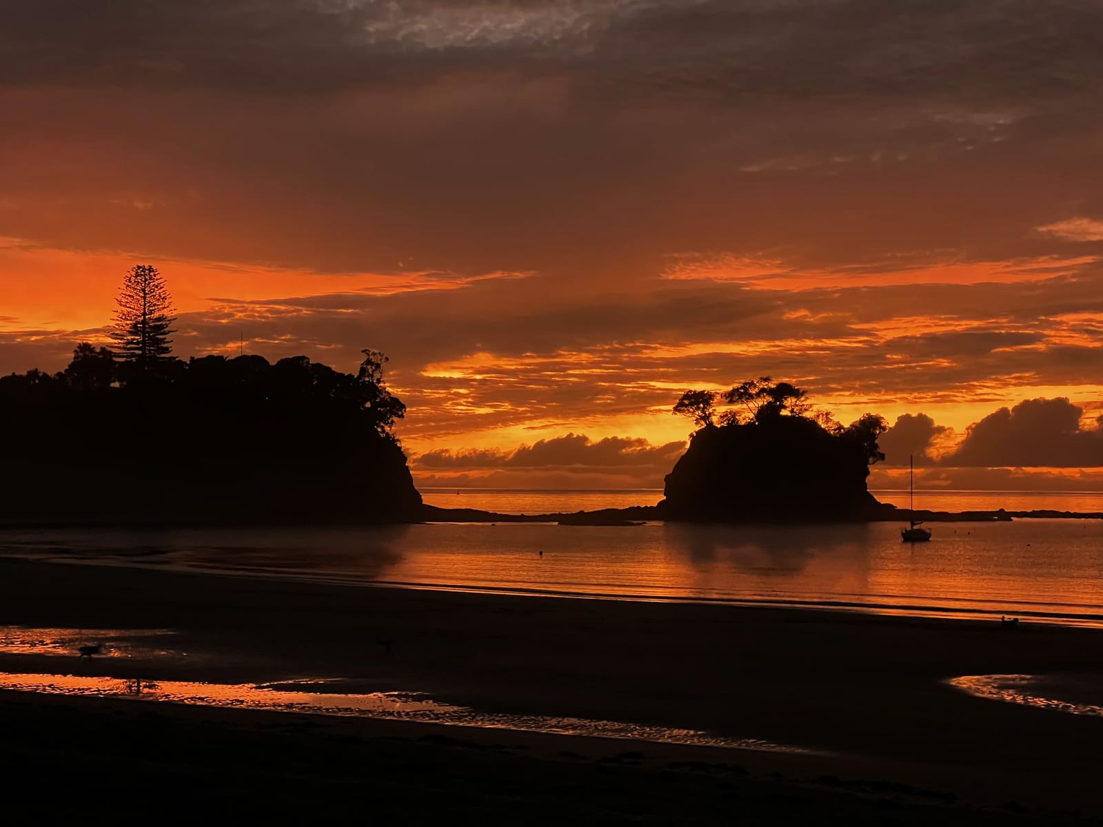 Fiery orange sunrise behind the Tor and the headland