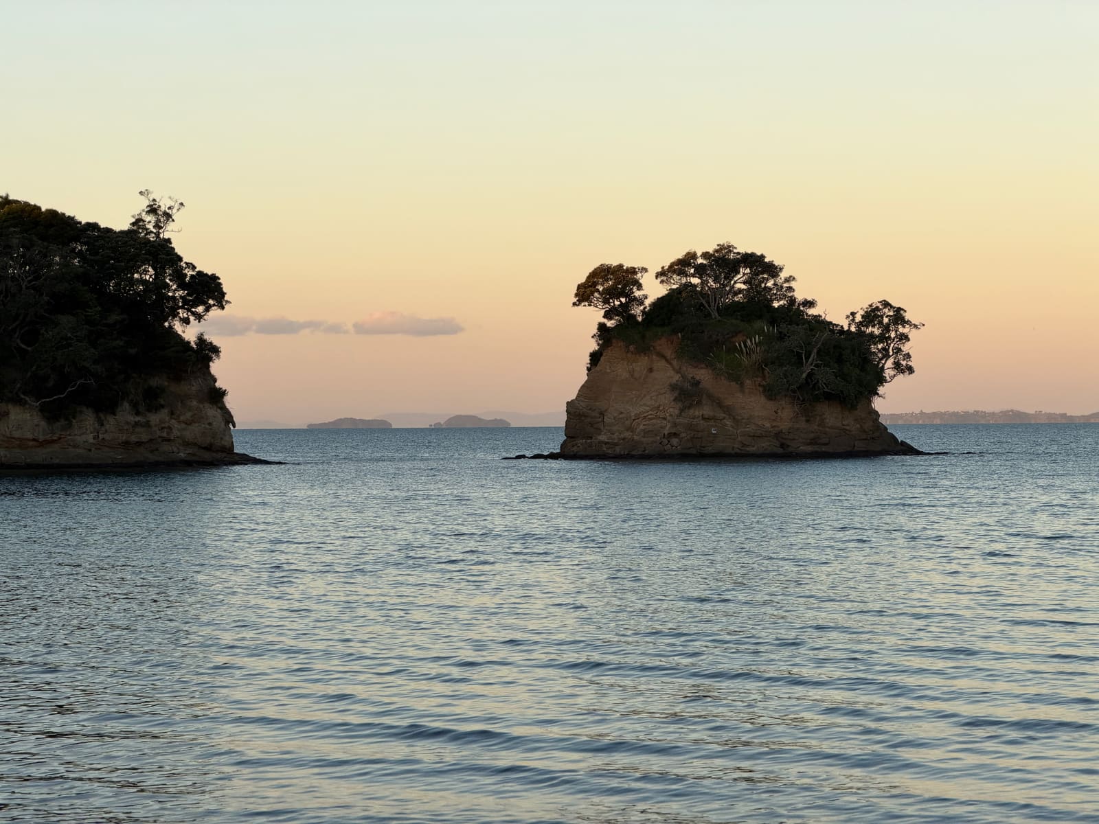 The Tor in pastel evening light on a calm sea