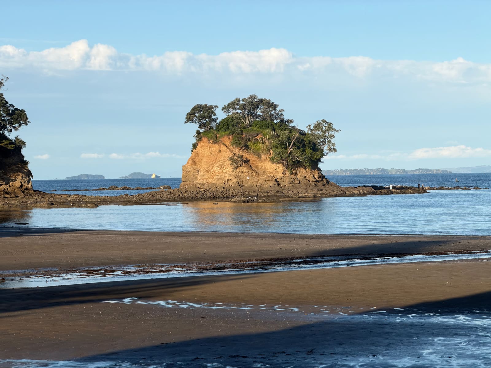 The Tor with tidal sandbars under a blue sky