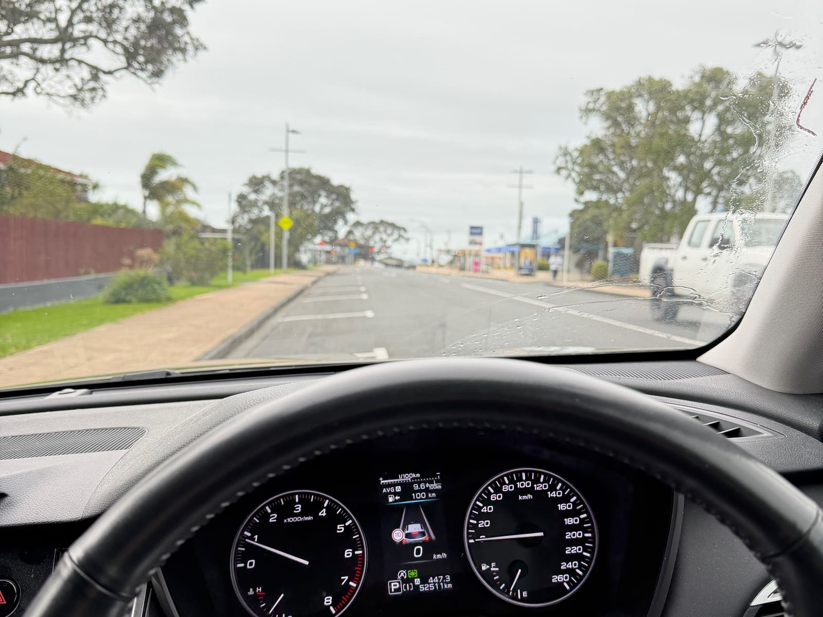 Torbay village from the driver's seat — the wheel on the right, the car on the left of the road